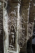 Ta Prohm temple - devatas sculpted on the gallery walls 
